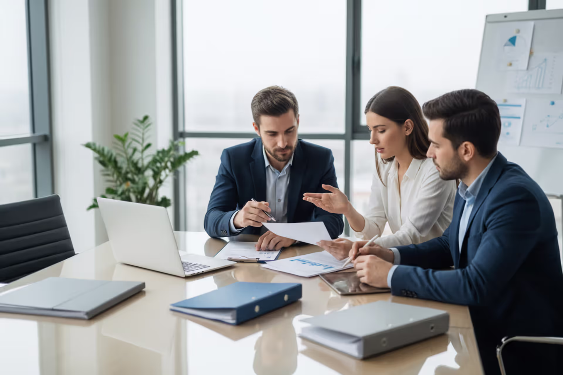Business partners discussing LLC formation documents in a meeting room